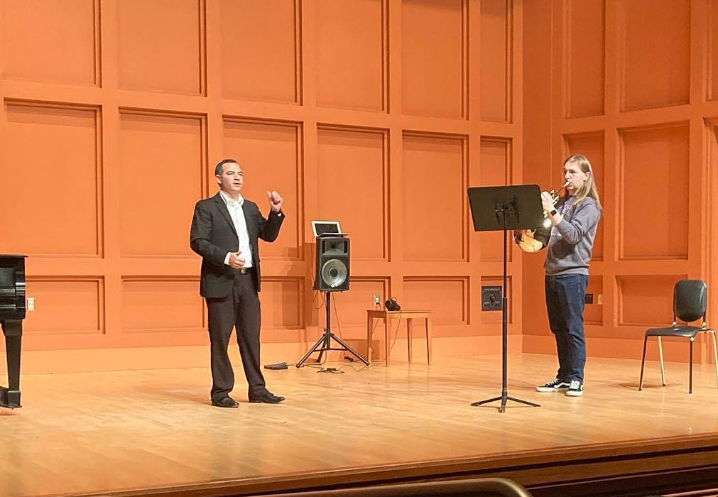 Horn players on stage performing