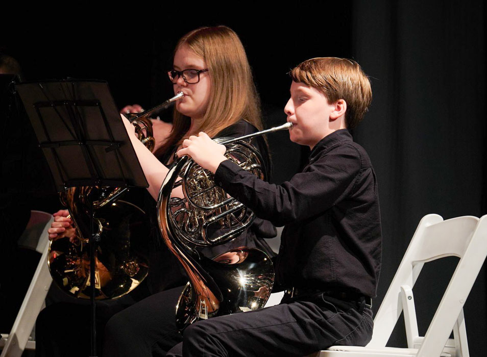 French horn players in an ensemble